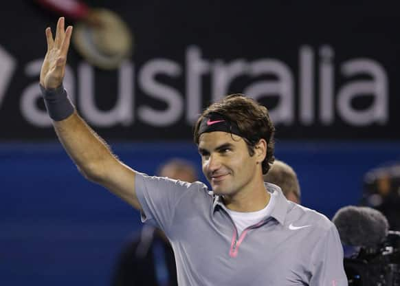 Switzerland's Roger Federer waves to the crowd after his fourth round win over Canada's Milos Raonic at the Australian Open tennis championship.