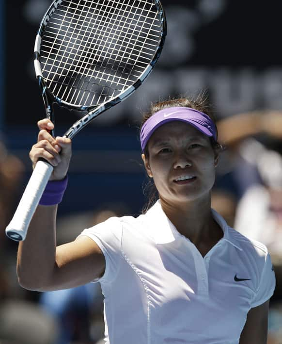 China's Li Na waves to the crowd as she celebrates her quarterfinal win over Poland's Agnieszka Radwanska at the Australian Open tennis championship.