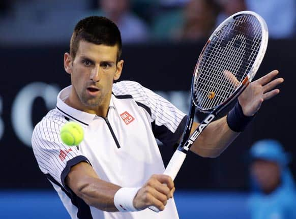 Serbia's Novak Djokovic hits a return to Tomas Berdych of the Czech Republic during their quarterfinal match at the Australian Open tennis championship in Melbourne.