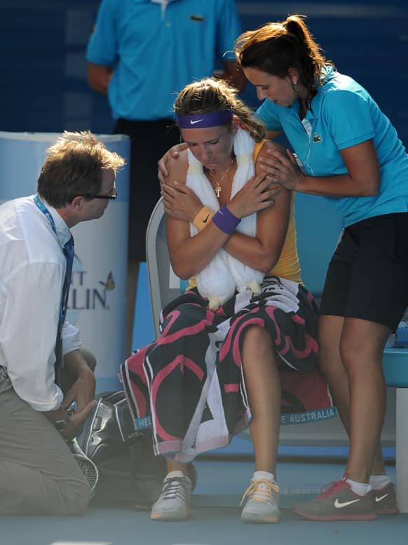 Victoria Azarenka of Belarus receives treatment from a trainer during her semifinal match against Sloane Stephens of the US at the Australian Open tennis championship.