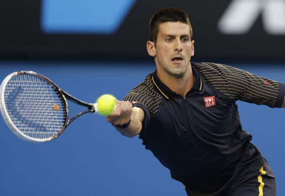 Serbia's Novak Djokovic hits a forehand return to Spain's David Ferrer during their semifinal match at the Australian Open tennis championship.