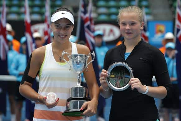 Croatia's Ana Konjuh, left, holds her trophy for photographers after winning the girl's singles final against Katerina Siniakova, right, of the Czech Republic at the Australian Open tennis championship in Melbourne.