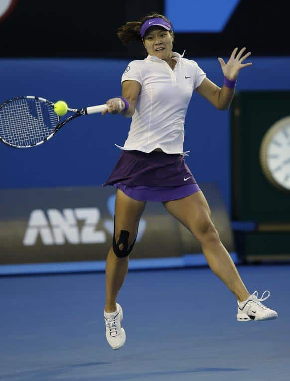 China's Li Na hits a forehand return to Victoria Azarenka of Belarus during the women's final at the Australian Open tennis championship in Melbourne.