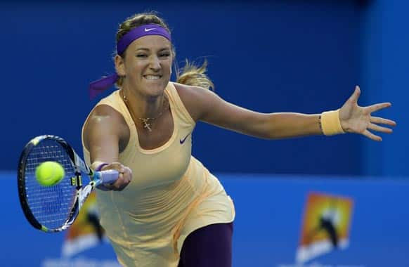 Victoria Azarenka of Belarus hits a forehand return to China's Li Na during the women's final at the Australian Open tennis championship in Melbourne.