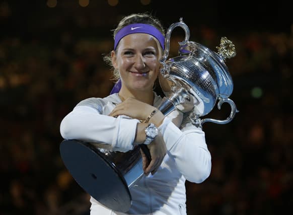 Victoria Azarenka of Belarus hugs her trophy after winning the women's final against China's Li Na at the Australian Open tennis championship in Melbourne.