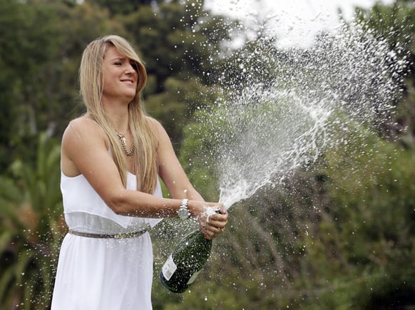 Victoria Azarenka of Belarus sprays champagne in the Royal Botanical Gardens following her win over China's Li Na in the Australian Open women's final, in Melbourne.