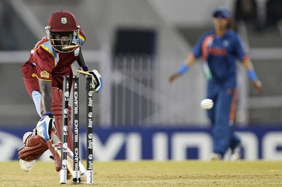 West Indies' cricketer Kycia Knight watches the bails being displaced resulting in her dismissal during the opening cricket match of the ICC Women's World Cup against India in Mumbai.