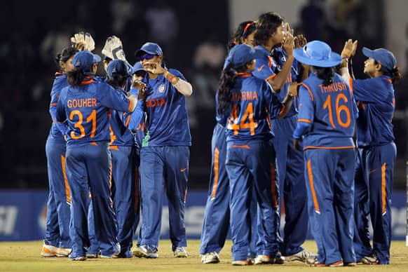 Indian cricketers celebrate their victory over West Indies during the opening match of the ICC Women's World Cup cricket in Mumbai.