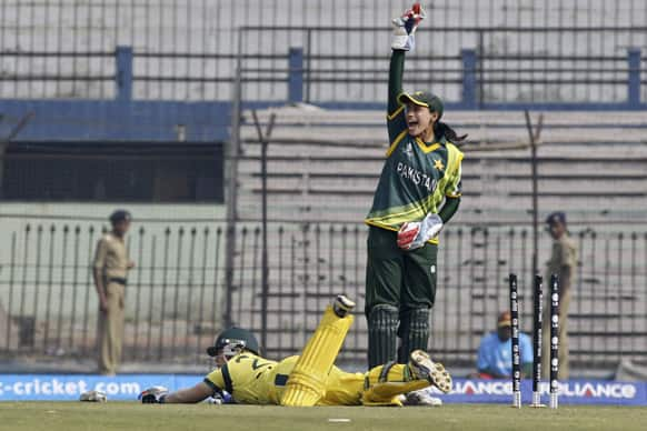 Australia’s Alex Blackwell falls on the ground after a successful attempt to reach the crease as Pakistan’s wicketkeeper Batool Fatima appeals during their ICC Women’s World Cup cricket match in Cuttack.