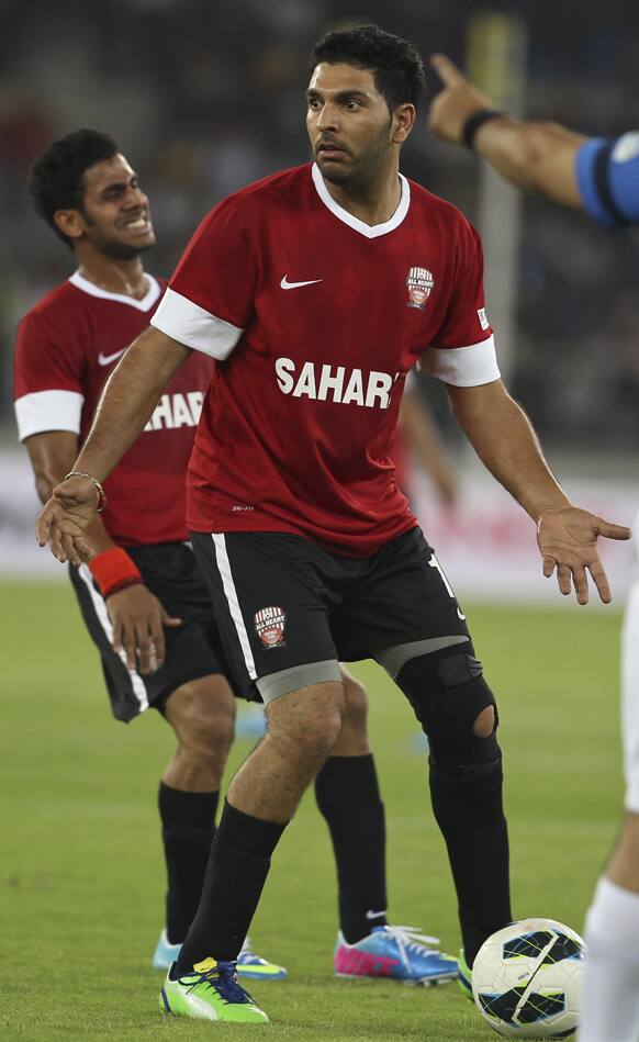 Yuvraj Singh, center, gestures as he reacts to a referee's decision during a charity soccer match played between Indian cricket players and Bollywood actors in New Delhi.