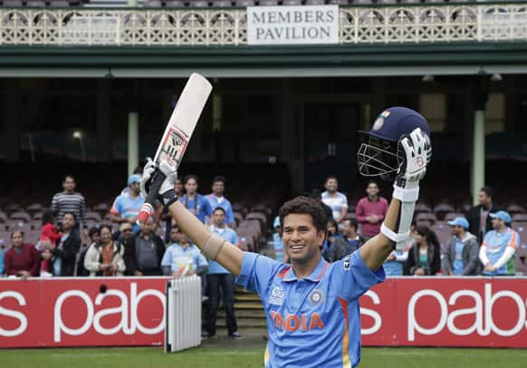 Indian cricket fans stand behind a wax statue of Sachin Tendulkar at the SCG in Sydney.