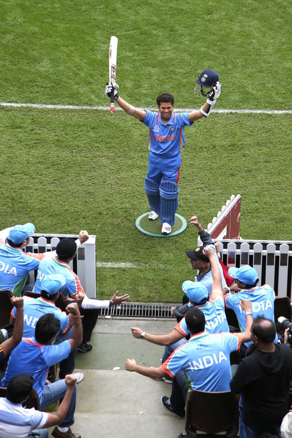 Indian cricket fans pretend to cheer for a wax statue of Sachin Tendulkar at the SCG in Sydney.