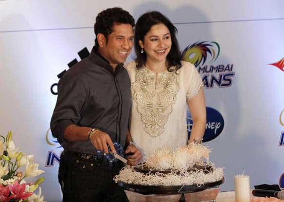 Sachin Tendulkar smiles as he cuts a cake beside his wife Anjali during celebration of his 40th birth day in Kolkata.