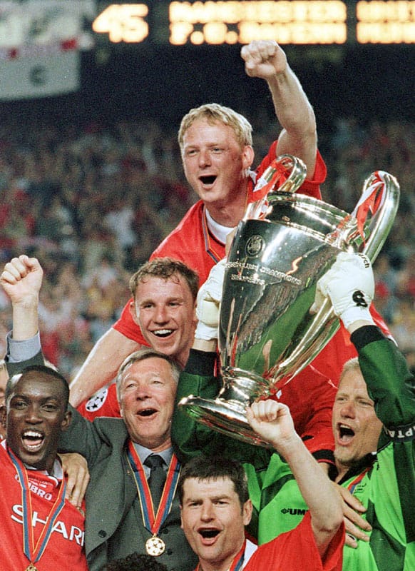 In this Wednesday, May 26, 1999 file photo Manchester United manager Alex Ferguson, 2nd left, celebrates with his players after they won the Champions League final soccer match at the Nou Camp Stadium in Barcelona, Spain.