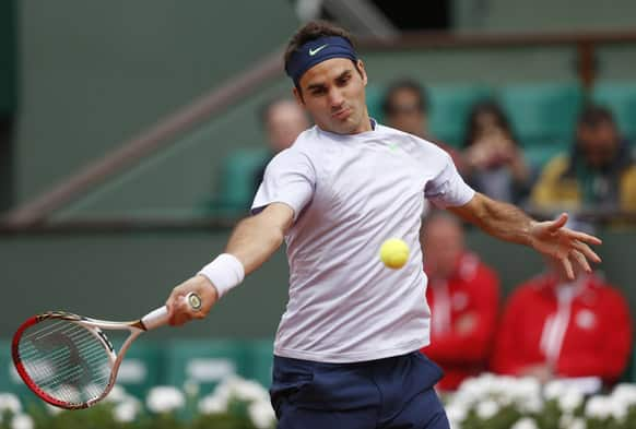 Switzerland's Roger Federer returns the ball to Spain's Pablo Carreno Busta during their first round match of the French Open tennis tournament at the Roland Garros stadium in Paris.