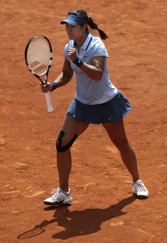 China's Li Na clenches her fist as she defeats Spain's Anabel Medina Garrigues during their first round match of the French Open tennis tournament at the Roland Garros stadium in Paris. Li Na won 6-3, 6-4. 