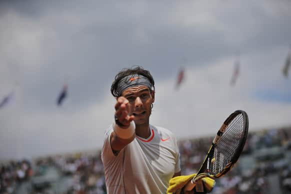 Spain's Rafael Nadal asks for the ball after it rolled into an underground press position in his first round match against Germany's Daniel Brands at the French Open tennis tournament at the Roland Garros stadium in Paris.