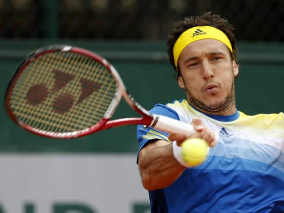 Argentina's Juan Monaco returns the ball to Spain's Daniel Gimeno Traver during their first round match of the French Open tennis tournament at the Roland Garros stadium in Paris.