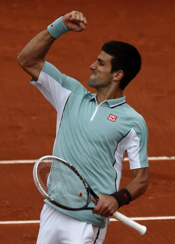 Serbia's Novak Djokovic reacts as he defeats Belgium's David Goffin during their first round match of the French Open tennis tournament at the Roland Garros stadium .