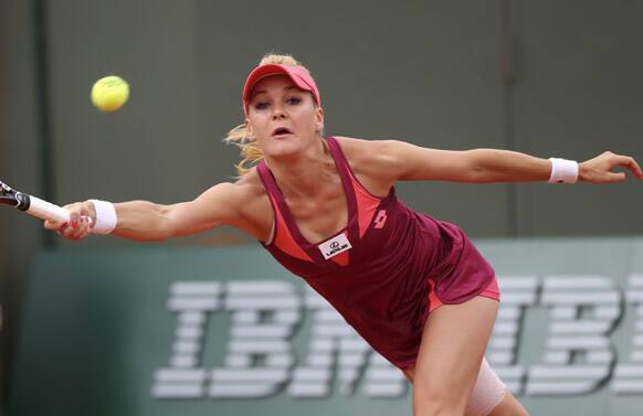 Poland's Agnieszka Radwanska returns the ball to Mallory Burdette, of the US, during their second round match of the French Open tennis tournament at the Roland Garros stadium.