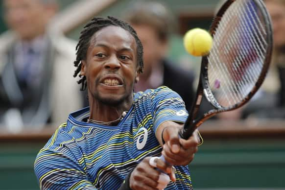 France's Gael Monfils returns against Latvia's Ernests Gulbis in their second round match of the French Open tennis tournament, at Roland Garros stadium in Paris.