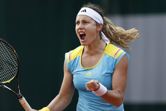 Switzerland's Stefanie Voegele celebrates defeating Estonia's Kaia Kanepi in their second round match at the French Open tennis tournament, at Roland Garros stadium in Paris. Voegele won in three sets 7-3, 3-6, 8-6. 