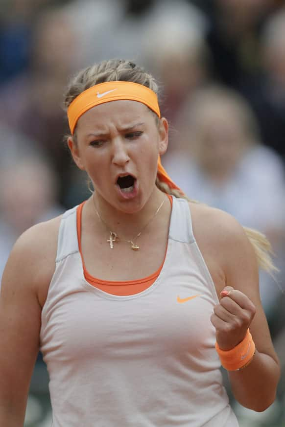 Victoria Azarenka of Belarus celebrates scoring a point against Alize Cornet of France in their third round match at the French Open tennis tournament, at Roland Garros stadium in Paris.