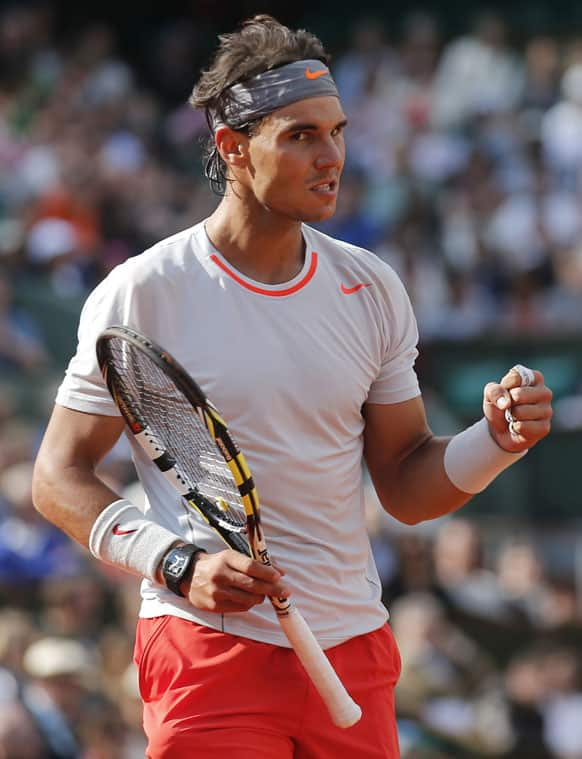 Defending champion Spain's Rafael Nadal clenches his fist as he plays Italy's Fabio Fognini during their third round match of the French Open tennis tournament at the Roland Garros stadium.