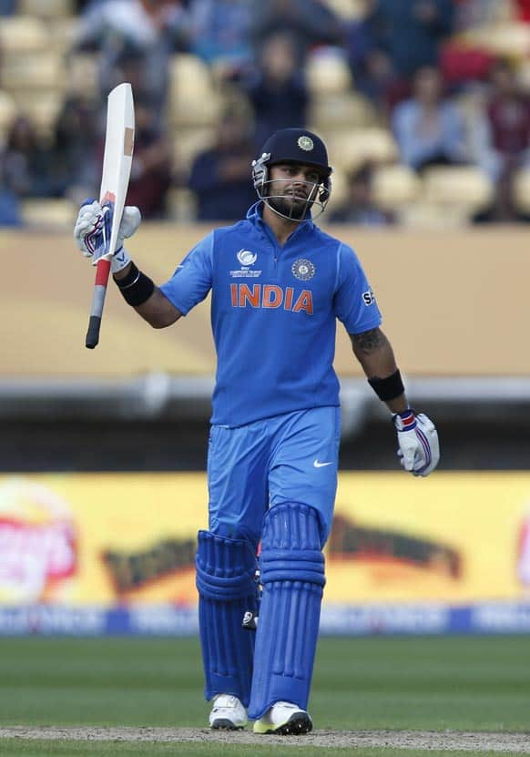 Virat Kohli reacts to his century he got against Sri Lanka during their ICC Champions Trophy warm-up cricket match at Edgbaston cricket ground in Birmingham.