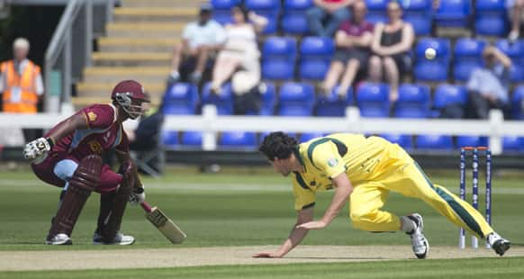 Australia's bowler Clint McKay, right,reacts late as West Indies Darren Bravo gets back to his crease during a warm up match for the upcoming ICC trophy, in Cardiff, Wales.