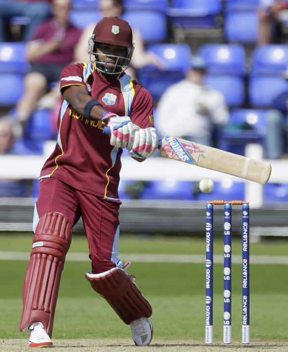 West Indies's Darren Bravo bats a ball bowled by Australia's James Faulkner, unseen, during a warm up cricket match for the upcoming ICC Champions Trophy, in Cardiff, Wales.