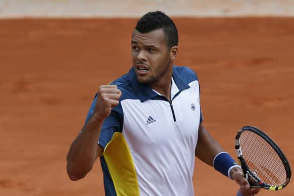 Jo-Wilfried Tsonga of France clenches his fist after scoring against Serbia's Viktor Troicki in their fourth round match at the French Open tennis tournament, at Roland Garros stadium in Paris.