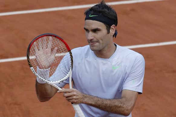 Switzerland's Roger Federer celebrates after defeating France's Gilles Simon in five sets 6-1, 4-6, 2-6, 6-2, 6-3, in their fourth round match at the French Open tennis tournament, at Roland Garros stadium in Paris.