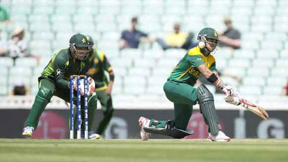 South Africa's Jean-Paul Duminy, right, hits a shot watched by Pakistan's wicketkeeper Kamran Akmal during a warm up cricket match for the upcoming ICC Championship Trophy between Pakistan and South Africa at The Oval cricket ground in London.