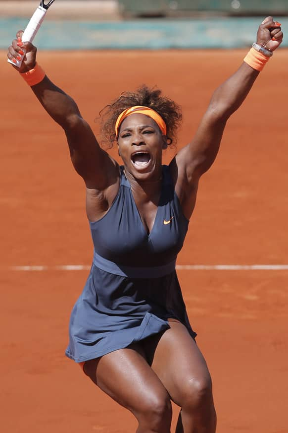 Serena Williams of the US celebrates winning against Russia's Svetlana Kuznetsova in three sets 6-1, 3-6, 6-3, in their quarterfinal match at the French Open tennis tournament, at Roland Garros stadium in Paris.