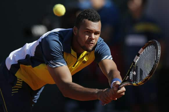 France's Jo-Wilfried Tsonga returns against Switzerland's Roger Federer, defeating Federer in three sets 7-5, 6-3, 6-3, in their quarterfinal match at the French Open tennis tournament, at Roland Garros stadium in Paris.