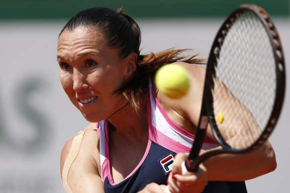 Serbia's Jelena Jankovic returns against Russia's Maria Sharapova in their quarterfinal match at the French Open tennis tournament, at Roland Garros stadium in Paris.