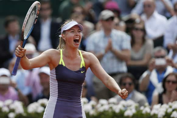 Russia's Maria Sharapova celebrates winning against Serbia's Jelena Jankovic in three sets 0-6, 6-4, 6-3, in their quarterfinal match at the French Open tennis tournament, at Roland Garros stadium in Paris.