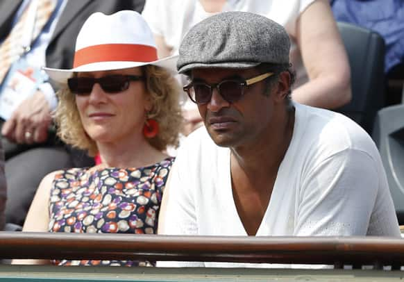 Former Roland Garros winner and musician Yannick Noah watches Russia's Maria Sharapova defeat Serbia's Jelena Jankovic in three sets 0-6, 6-4, 6-3, in their quarterfinal match at the French Open tennis tournament, at Roland Garros stadium in Paris.