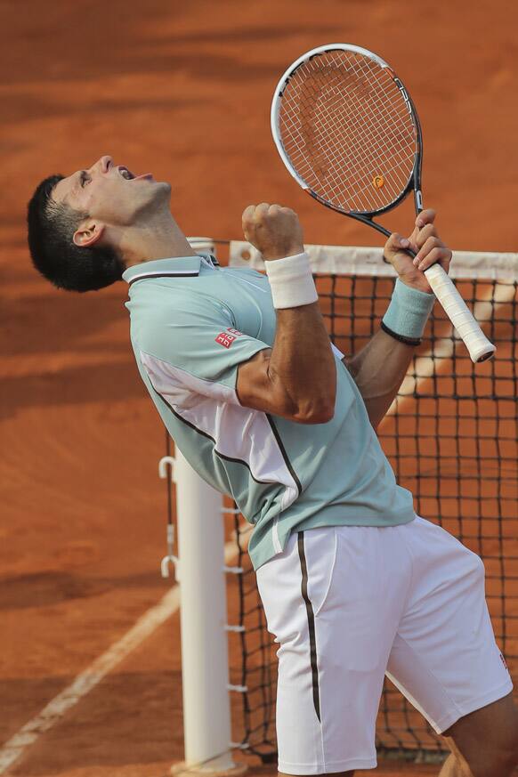 Novak Djokovic celebrates defeating Germany's Tommy Haas in three sets 6-3, 7-6, 7-5, in their quarterfinal match at the French Open tennis tournament, at Roland Garros stadium in Paris.