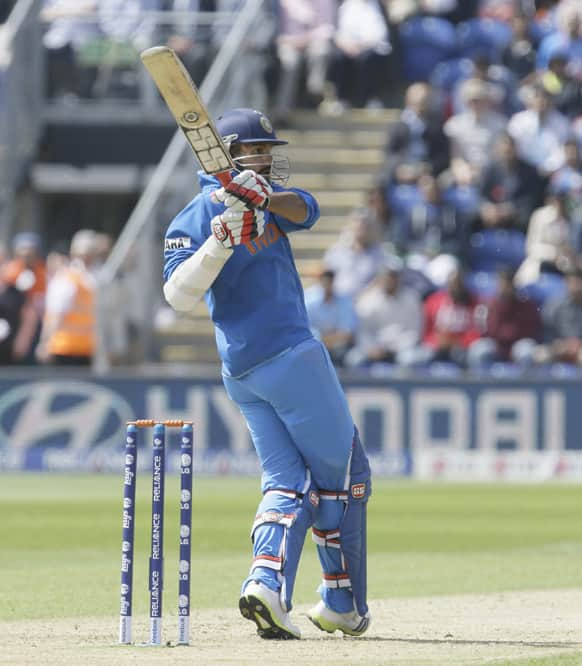 Shikhar Dhawan hits a ball for four runs off the bowling of South Africa's Rory Kleinveldt during their group stage ICC Champions Trophy cricket match in Cardiff, Wales.