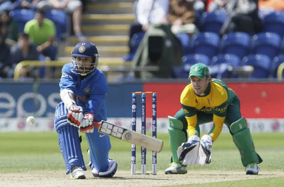 Shikhar Dhawan hits four runs off the bowling of South Africa's JP Duminy during their group stage ICC Champions Trophy cricket match in Cardiff, Wales.