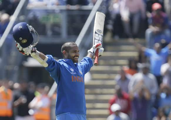 Shikhar Dhawan reacts as he reaches 100 runs not out as he plays against South Africa during their group stage ICC Champions Trophy cricket match in Cardiff, Wales.