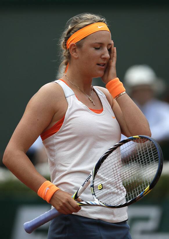 Belarus’ Victoria Azarenka reacts as she plays Russia’s Maria Sharapova during their semifinal match of the French Open tennis tournament at the Roland Garros stadium.