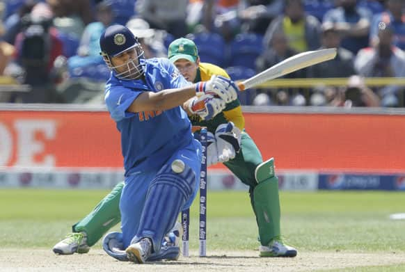 Mahendra Singh Dhoni plays and misses a ball from South Africa's JP Duminy during their group stage ICC Champions Trophy cricket match in Cardiff, Wales.