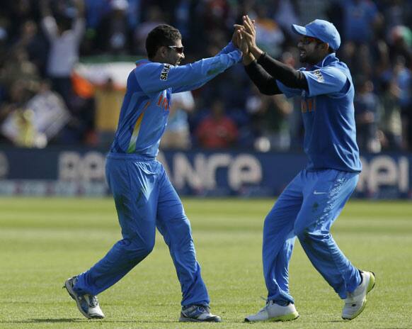 Ravindra Jadeja, left, celebrates with teammate Virat Kohli after taking a catch to dismiss South Africa's AB de Villiers, unseen, during their group stage ICC Champions Trophy cricket match in Cardiff, Wales.