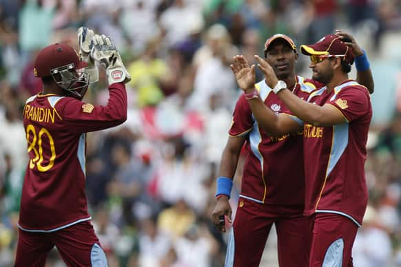 West Indies' Ravindranath Rampaul, right, celebrates the wicket of Pakistan's Nasir Jamshed with teammates during their ICC Champions Trophy group B cricket match at the Oval cricket ground in London.