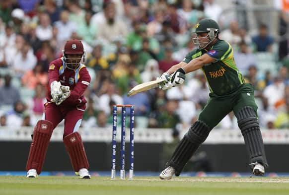 Pakistan's Kamran Akmal is caught out by West Indies' wicket keeper Denesh Ramdin during their ICC Champions Trophy group B cricket match at the Oval cricket ground in London.