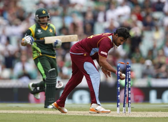 West Indies' Ravindranath Rampaul runs out Pakistan's Saeed Ajmal during their ICC Champions Trophy group B cricket match at the Oval cricket ground in London.