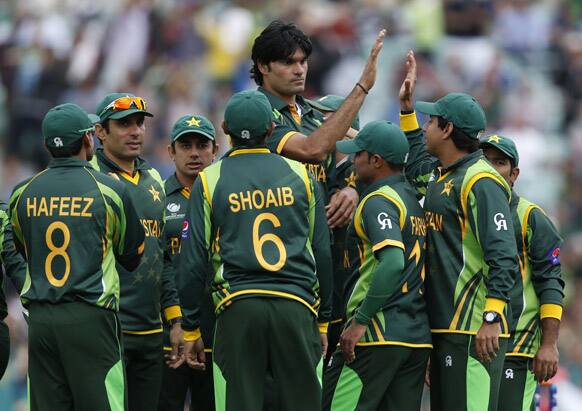 Muhammad Irfan celebrate with teammates the wicket of West Indies Darren Bravo caught by teammate Kamran Akmal during their ICC Champions Trophy group B cricket match at the Oval cricket ground in London.